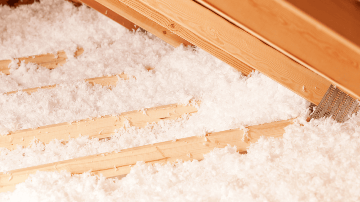 A close-up of attic insulation that is bright white and clean.