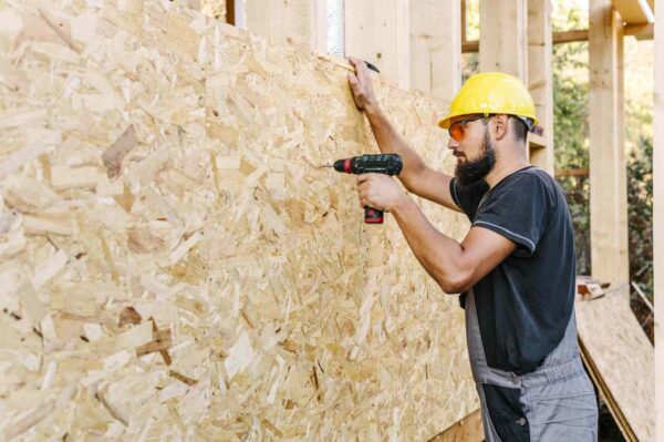 A man installing wall insulation